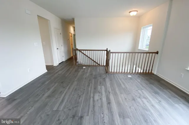 wooden floor in a hall with a window