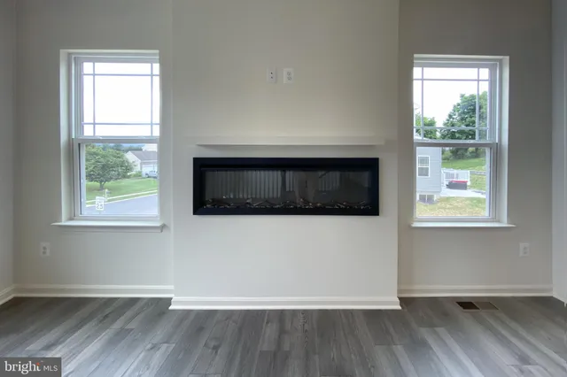 a view of a livingroom with wooden floor and a window