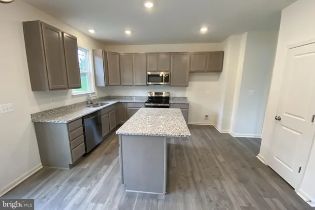 a kitchen with a sink stove and refrigerator