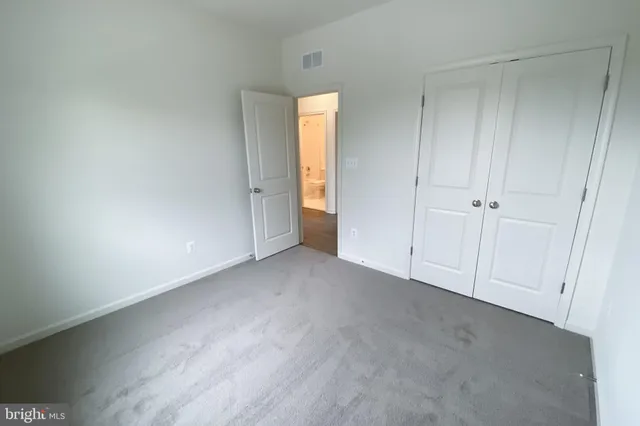 a view of an empty room and a window