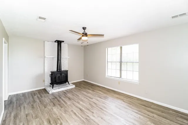 a view of room with workspace and wooden floor