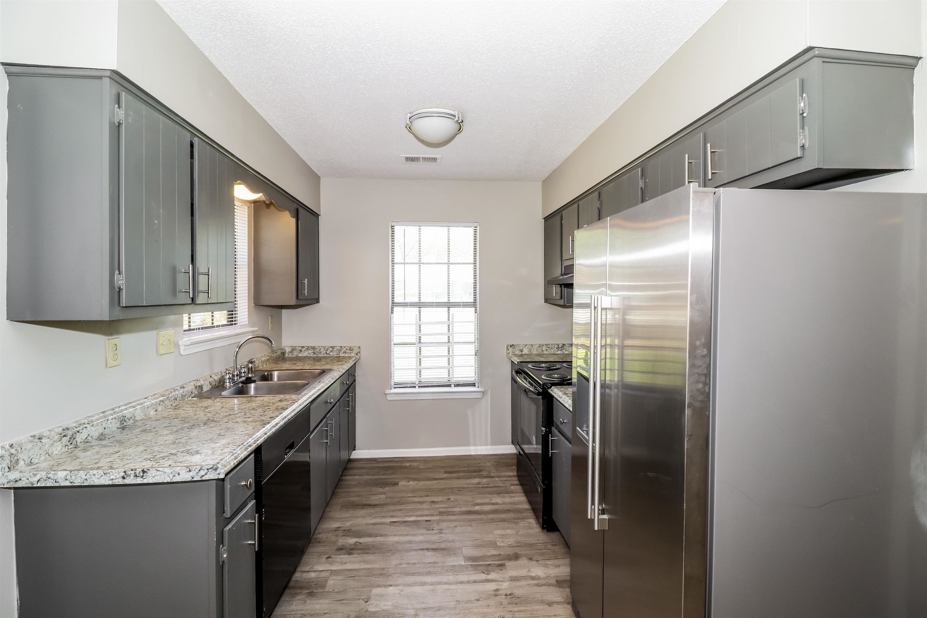 3917 Kerwin Drive Memphis, TN 38128 - Photo 6 of 16 a kitchen with stainless steel appliances granite countertop a sink stove and refrigerator
