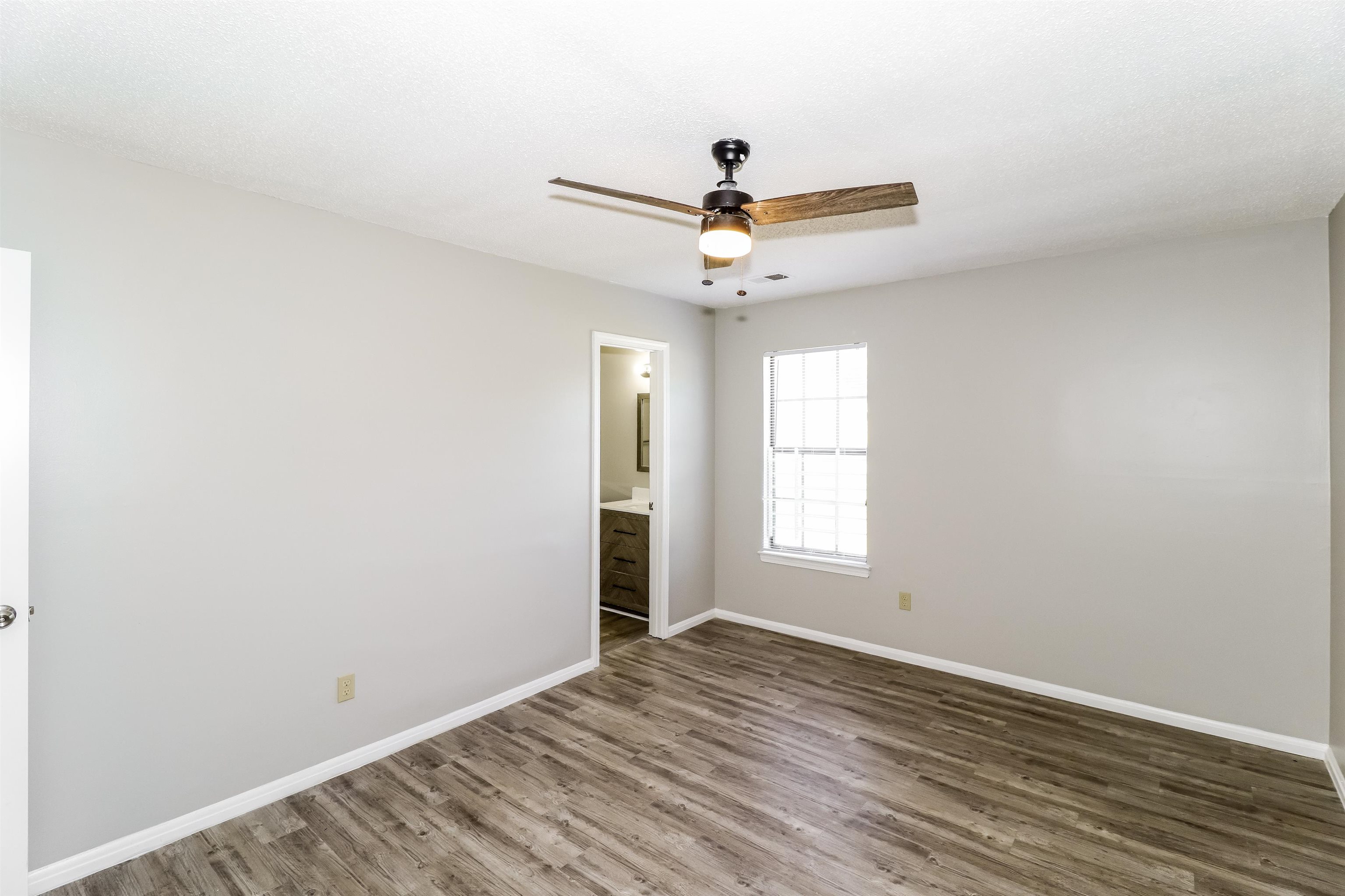 3917 Kerwin Drive Memphis, TN 38128 - Photo 9 of 16 an empty room with wooden floor and windows