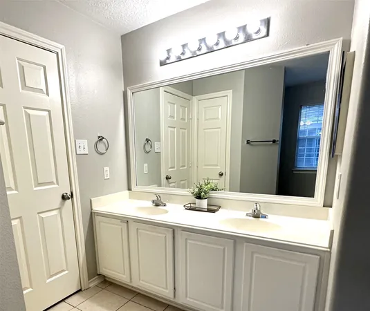 a bathroom with a double vanity sink and mirror