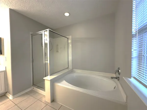 a bathroom with a tub and shower