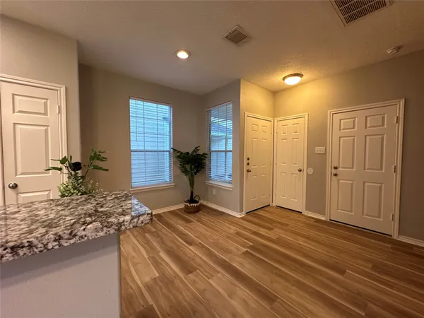 a spacious bathroom with a granite countertop sink and a mirror