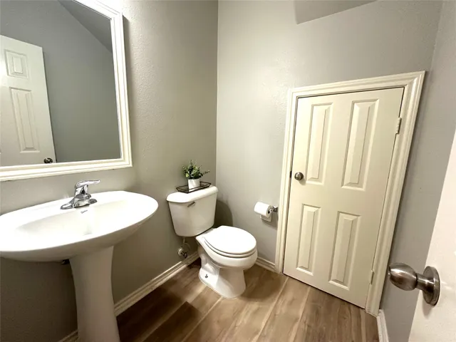 a bathroom with a sink toilet and a mirror