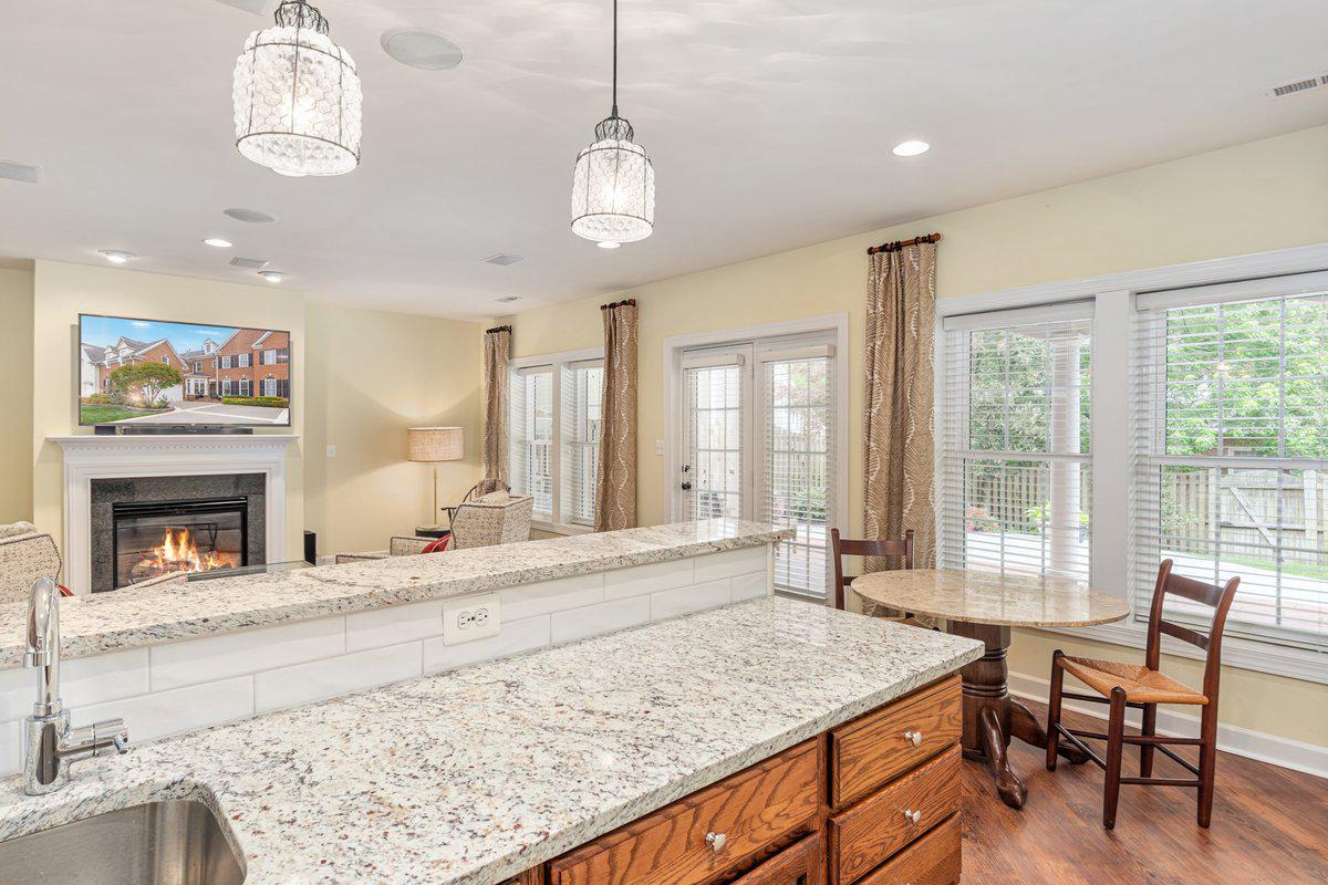 19194 Greystone Square Leesburg, VA 20176 - Photo 51 of 96 Granite and pendants lights elevate the bar