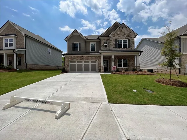 a front view of a house with yard