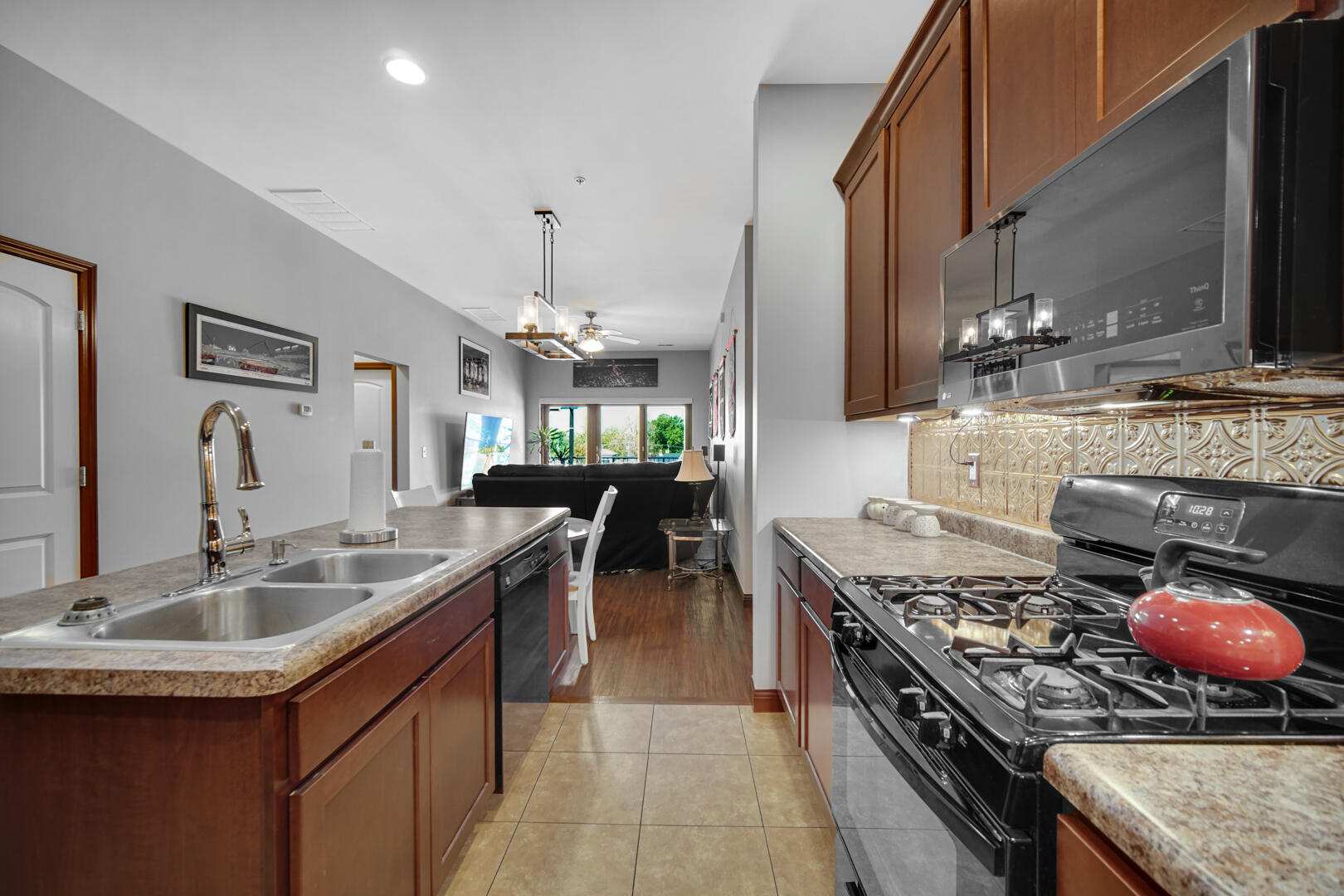 123 North Main Street, Unit 301 Crown Point, IN 46307 - Photo 3 of 25 a kitchen with a stove a sink and a refrigerator