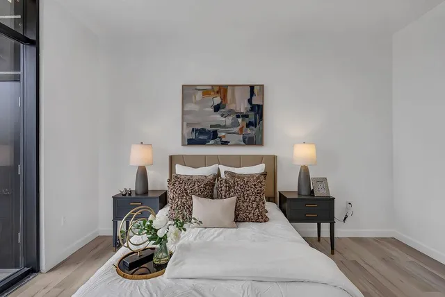 a bedroom with a bed and a lamp