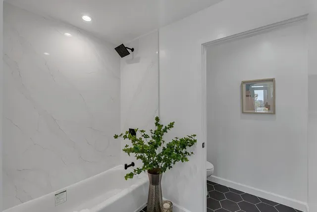 a white vase with flowers