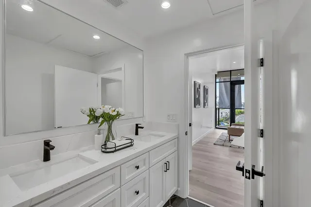 a bathroom with a double vanity sink and a