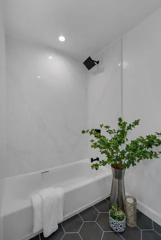 a bedroom with bed and a window