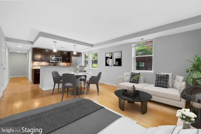 a living room with furniture a dining table and a kitchen view