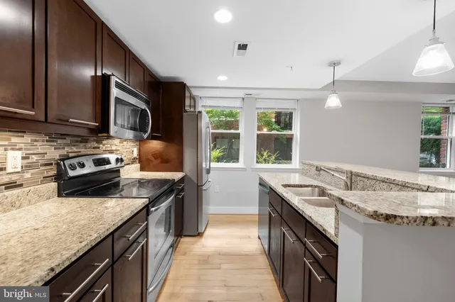 a kitchen with a stove sink and microwave
