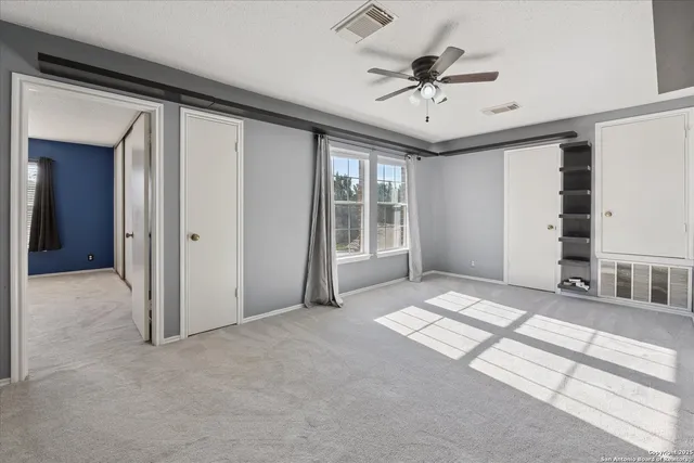 a view of a livingroom with a ceiling fan and window