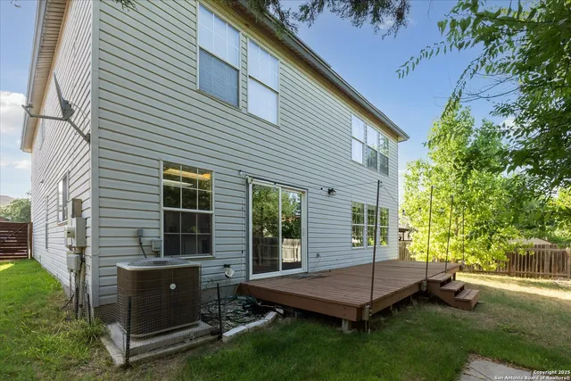 a view of a backyard with a table and a chairs