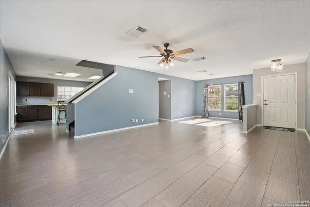 a view of livingroom with hardwood floor and ceiling fan