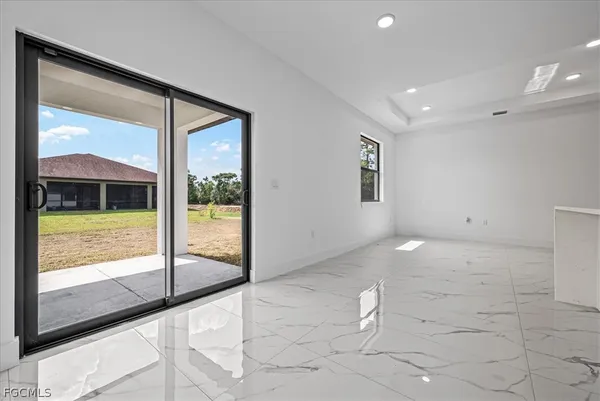 a view of an empty room and bathroom