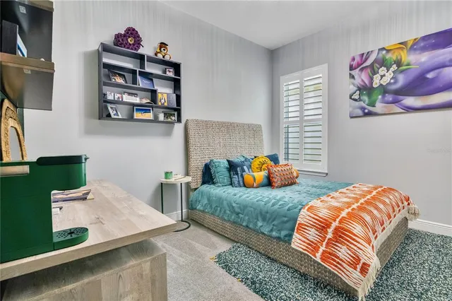 a bedroom with two beds and painting on the wall