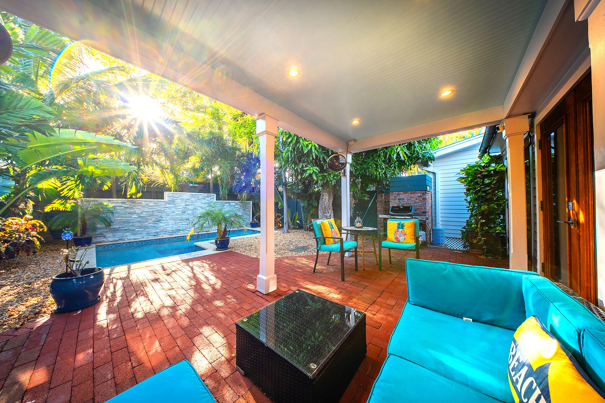 1116 Packer Street Key West, FL 33040 - Photo 28 of 57 a living room with patio furniture and a floor to ceiling window