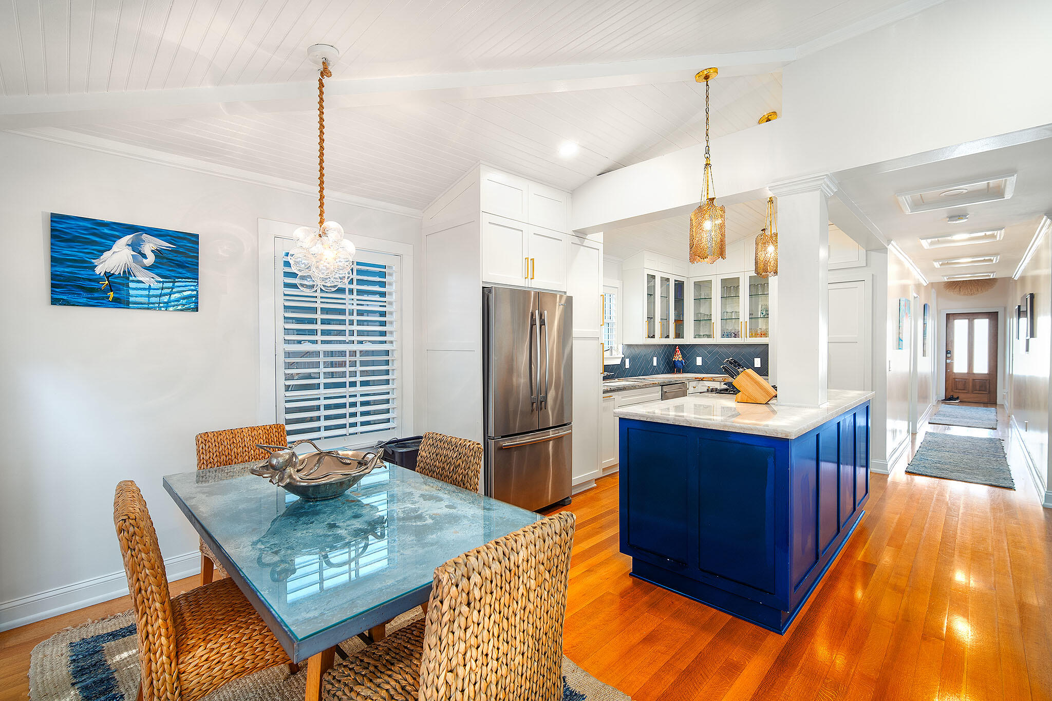 1116 Packer Street Key West, FL 33040 - Photo 33 of 57 a kitchen with stainless steel appliances kitchen island granite countertop a table chairs and a wooden floor