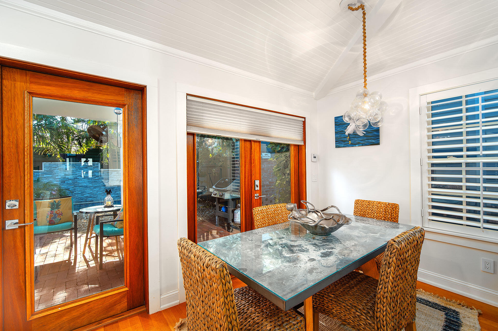 1116 Packer Street Key West, FL 33040 - Photo 41 of 57 a dining room with a table chairs and a wooden floor