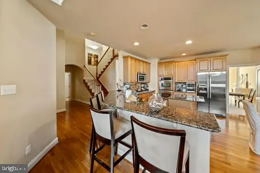 a kitchen with granite countertop a sink and a stove