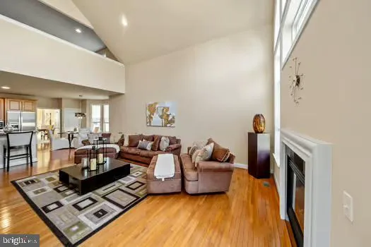 a living room with furniture a large window and a flat screen tv