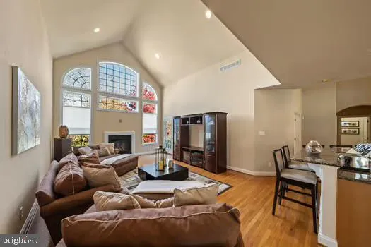 a living room with furniture a flat screen tv and a floor to ceiling window