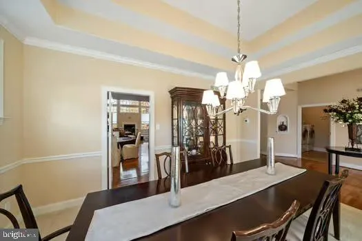 a view of a dining room with furniture and a chandelier