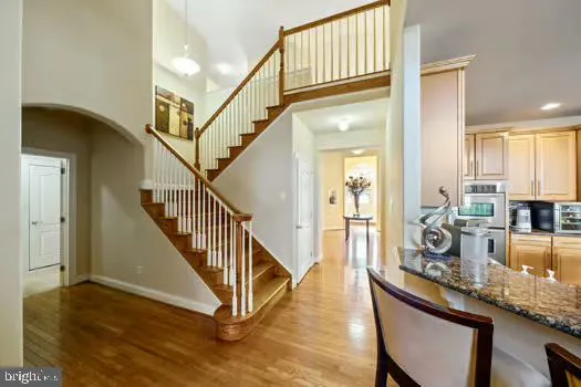 a living room with furniture a fireplace and large windows