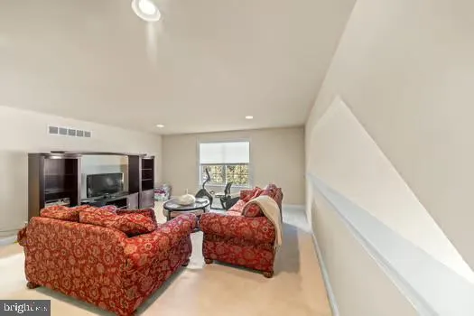 a room with furniture a refrigerator and a window