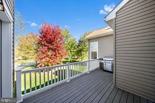 a view of a balcony with chairs and wooden floor