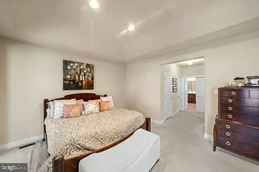 a bedroom with a bed and cabinets