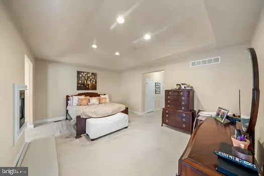 a bedroom with furniture and a flat screen tv