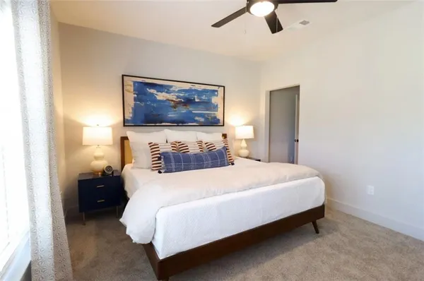 a bedroom with a bed and ceiling fan