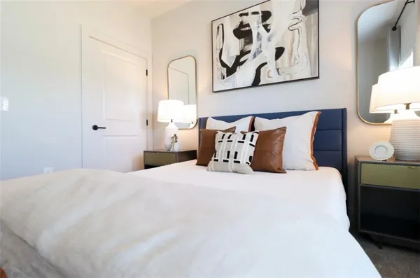 a large white bed in a white room