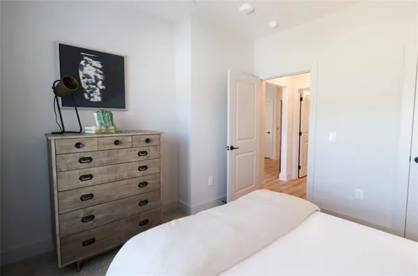 a bedroom with a bed and a dresser