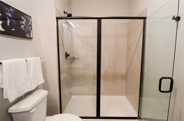 a bathroom with a glass shower door