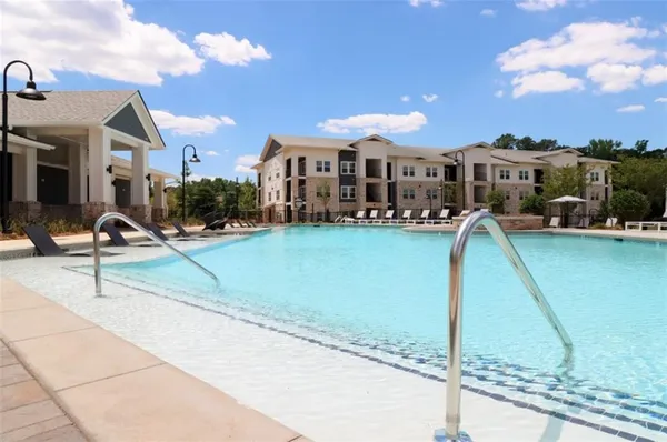 a view of a swimming pool and lounge chair