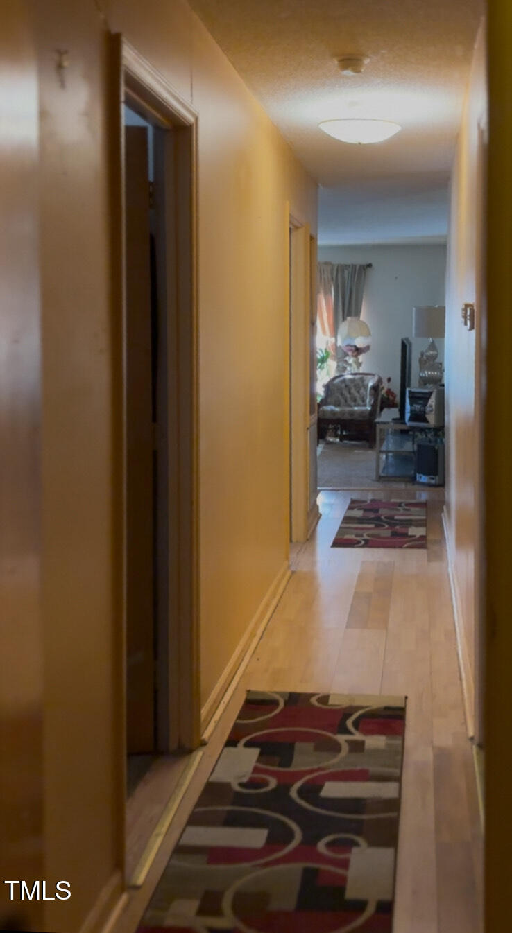 309 Cody Street Durham, NC 27703 - Photo 18 of 22 a room with a bed and a view of living room