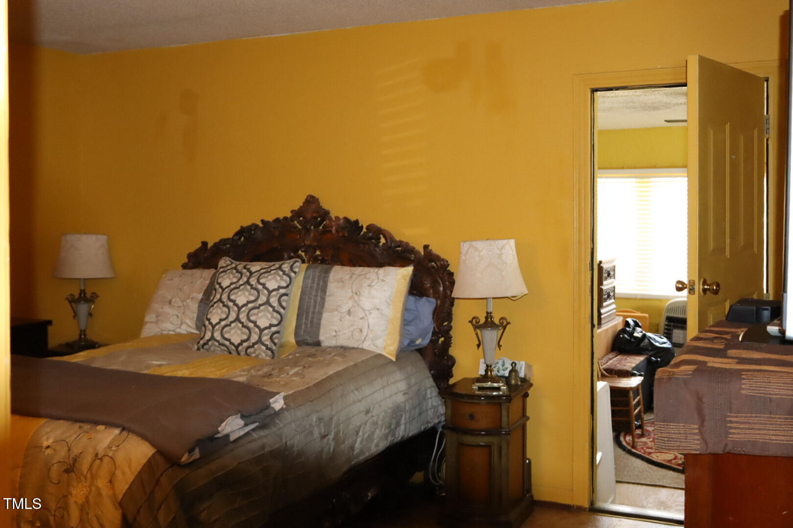 309 Cody Street Durham, NC 27703 - Photo 20 of 22 a bedroom with a bed and wooden floor