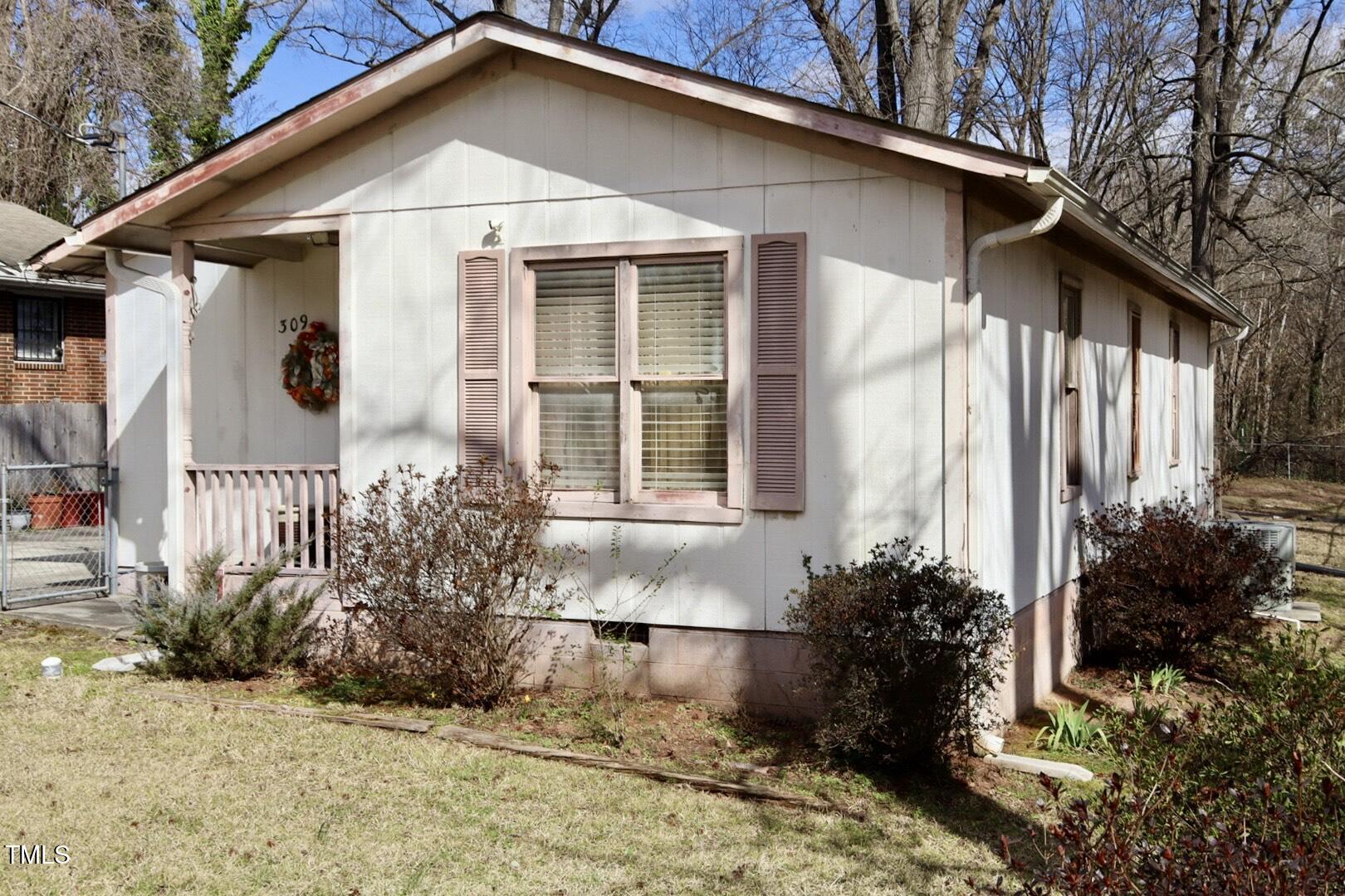 309 Cody Street Durham, NC 27703 - Photo 2 of 22 a front view of a house with garden