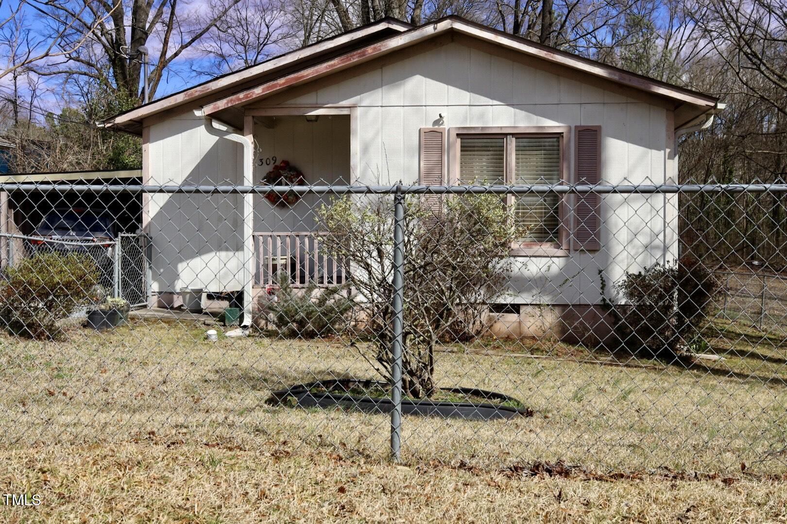 309 Cody Street Durham, NC 27703 - Photo 3 of 22 a front view of a house with garden