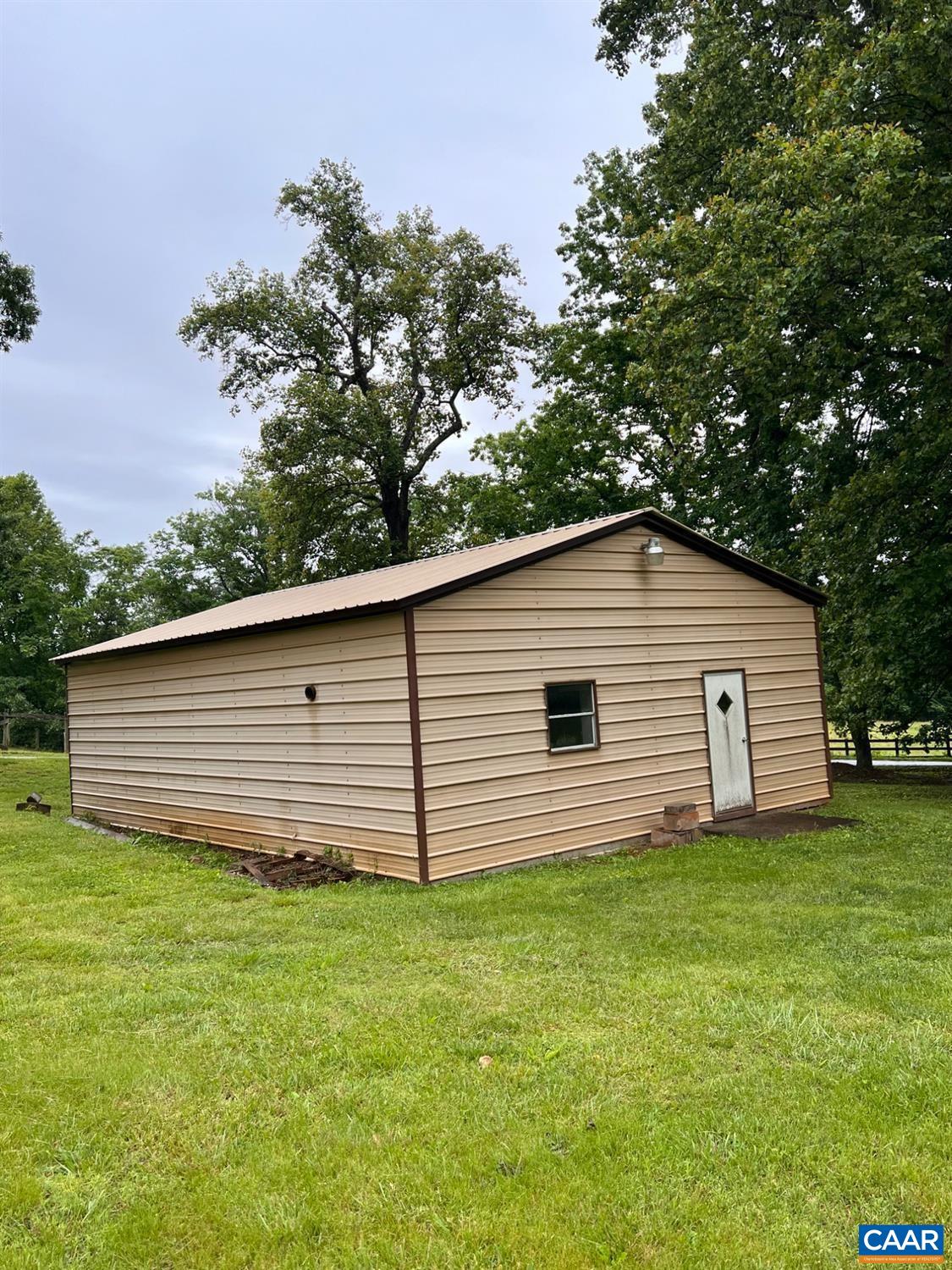 166 Matohe Road Monroe, VA 24574 - Photo 11 of 12 a backyard of a house with plants and large tree
