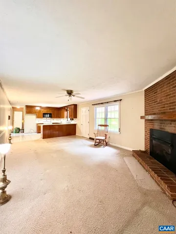 a view of a livingroom with a fireplace and a large window