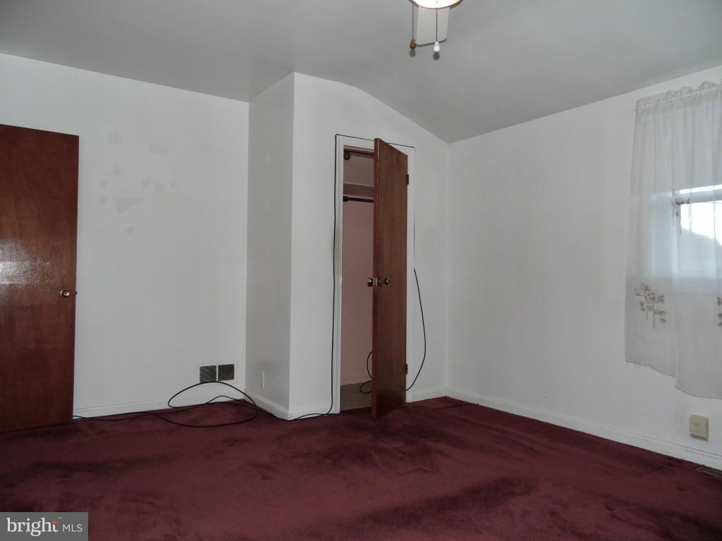 11245 Old Frederick Road Marriottsville, MD 21104 - Photo 11 of 22 a view of an empty room with wooden floor and closet