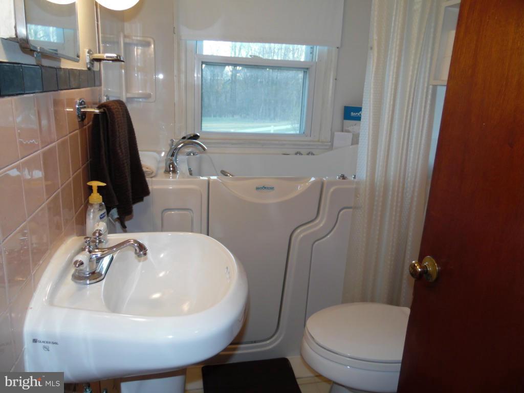 11245 Old Frederick Road Marriottsville, MD 21104 - Photo 15 of 22 a bathroom with a sink a toilet and a mirror